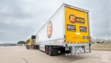 a rearview of an Estes tractor-trailer in a parking lot