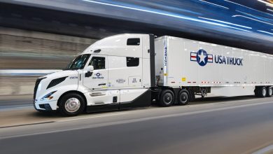blurred photo of a USA Truck tractor-trailer passing through a tunnel at night