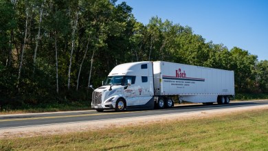A white Koch Cos. truck and trailer on a highway