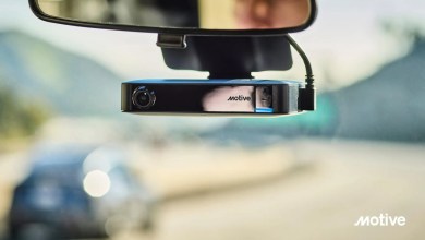 Motive AI Dashcam Plus mounted on a vehicle windshield below the rearview mirror, showing the sleek black device with forward-facing camera lens and Motive branding, designed for advanced fleet safety and real-time AI risk detection.