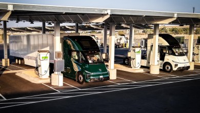 Windrose Global E700 electric semi-trucks charging at a Greenlane network megawatt charging station with solar canopy in Colton, California
