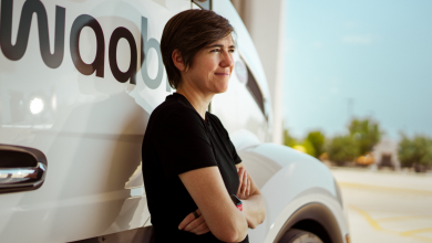 Raquel Urtasun, founder and CEO of Toronto-based autonomous trucking startup Waabi, leans against a Waabi-branded self-driving truck