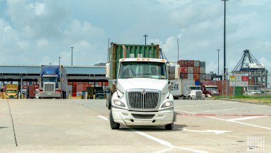 trucks leaving a port with containers