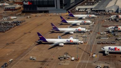 Purple-tailed FedEx planes lined up in a row at the FedEx main cargo terminal.