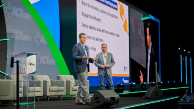 Two speakers on stage at ACT Expo presenting key lessons learned in electric truck deployment, including matching innovation to application, early utility engagement, and scalable depot planning for commercial fleets