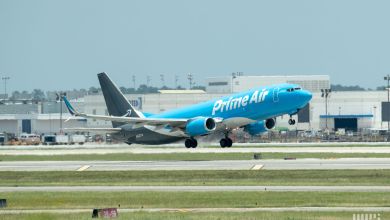 A light-blue Amazon Prime cargo jet takes off.