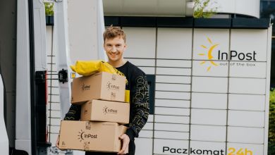 An InPost courier picks up packages from a parcel locker.