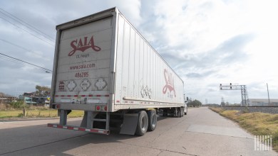 a closeup of a Saia trailer at a rail crossing