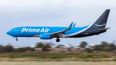A two-tone blue Amazon Prime Air jet comes in for a landing.