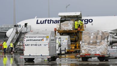 Side view of a Lufthansa Cargo jet being loaded through side cargo door.