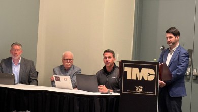 John Hitch speaks at the TMC podium during the Fullbay State of Heavy-Duty Repair Report 2026 panel as Fullbay CEO Trent Broberg, Peter Cooper of Ascend Consulting, and Jack Poster of the American Trucking Associations sit at the table at the Technology & Maintenance Council Annual Meeting in Nashville.