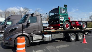New Volvo VNR 300 regional truck displayed next to a vintage green Volvo 535 cab on a Jerr-Dan flatbed trailer during the 2026 VNR Ride and Drive event at Volvo Trucks’ Dublin, Virginia plant.