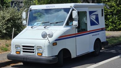 Closeup, front view of a U.S. Postal Service delivery van.