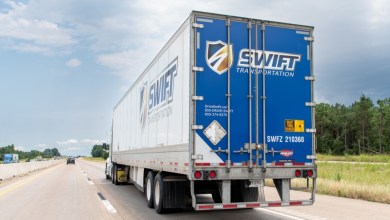 a Swift trailer being pulled on a highway