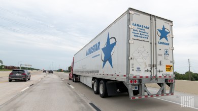 rearview of a Landstar trailer being pulled on a highway
