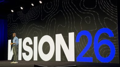 Motive CEO Shoaib Makani stands on stage during the Vision 26 keynote in front of a large screen displaying 'VISION 26' at the JW Marriott Nashville.