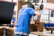 A worker fills e-commerce orders in a warehouse.