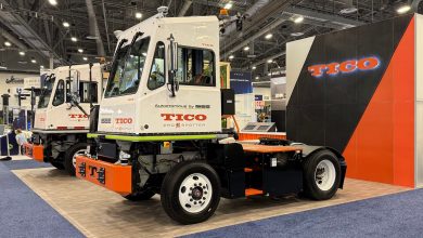 TICO Pro Spotter autonomous yard truck by ISEE AI at ACT Expo, showing roof-mounted sensors, orange safety accents, and fifth-wheel hitch on the white terminal tractor.
