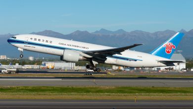 A China Southern Cargo jet, painted with a light-blue tail, lifts off the runway.