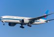 A China Southern Cargo freighter aircraft approaches an airport with wheels down.