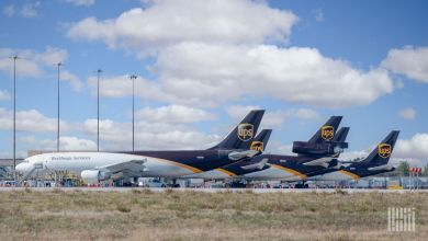Brown-tailed UPS planes seen side by side at an airport.