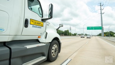 a closeup of a JB Hunt dedicated tractor on a highway