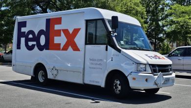 A FedEx delivery van sits in a parking lot.