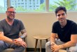 John Hummel (left), newly named president of Grip Fulfillment, and Grip founder and CEO Juan Camilo Meisel sit together in a modern office.