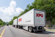 two XPO trailers being pulled on a highway
