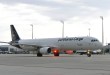 A blue-tailed Lufthansa Cargo jet moves on an airport taxiway.