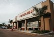 A Florida Home Depot location with a palm tree at the entrance.