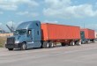 trucks leaving a port with ocean containers