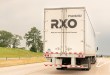 a rearview of an RXO dryvan trailer on a highway
