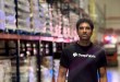 DeepFabric CEO Kalyan Kommineni stands in a Kenco warehouse aisle among pallet racks