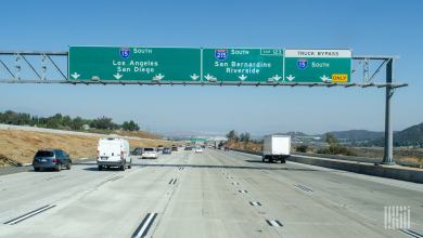 Southbound Interstate 15 and 215 split in Southern California, with a box truck in the I-15 truck bypass lane toward Los Angeles and San Diego.
