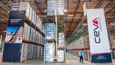An inside view of a Ceva Logistics warehouse with rows of filled storage racks.