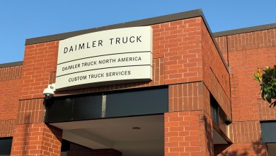 Daimler Truck North America Custom Truck Services entrance sign on brick building