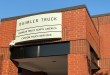 Daimler Truck North America Custom Truck Services entrance sign on brick building