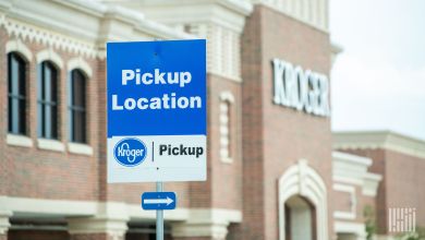 A Kroger pickup location sign is displayed outside a brick building.