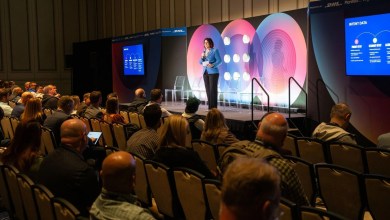 Kara Brown, CEO and co-founder of LeadCoverage, speaks on stage about intent data and AI-driven marketing at a supply chain conference