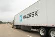 Maersk semi-truck hauling a white trailer with the company logo on a multi-lane highway.