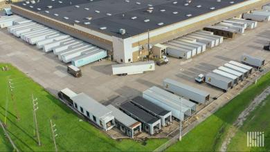UPS distribution center with trailers at loading docks, representing freight capacity and shipping costs