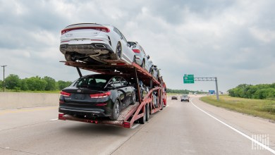 a loaded auto hauler on a highway