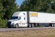 a white Werner tractor-trailer on a highway