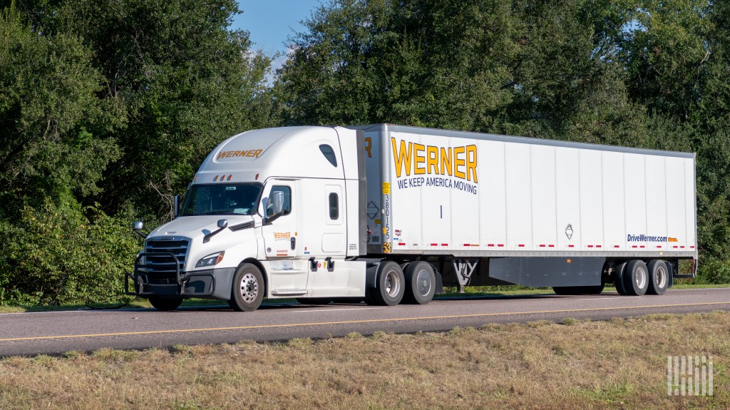 a white Werner tractor-trailer on a highway