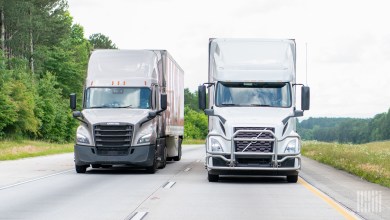 front view of two tractor-trailers on a highway