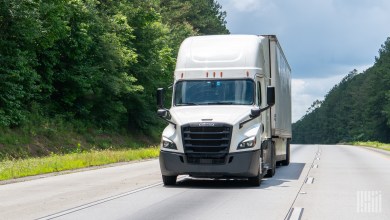 a white tractor-trailer on a highway