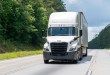 a white tractor-trailer on a highway