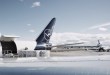 Blue-tailed Lufthansa Cargo jet gets loaded in side door with pallet.