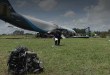 An Amazon Prime Air, nose down with a damaged engine piece sitting in a field after an accident at Miami airport.